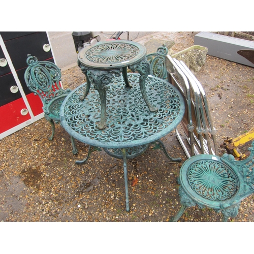 3310 - A cast iron table with three chairs and a stool