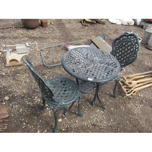 3614 - A cast alloy garden table with two chairs