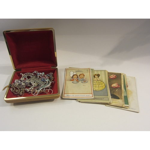 4316 - A box of bijouterie: costume jewellery, postcards to include Mabel Lucie Attwell, cutlery with some ... 