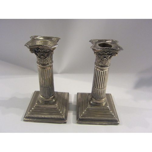 4318 - A pair of silver Corinthian column candlesticks, London 1897 James Charles Jay, approximately 6