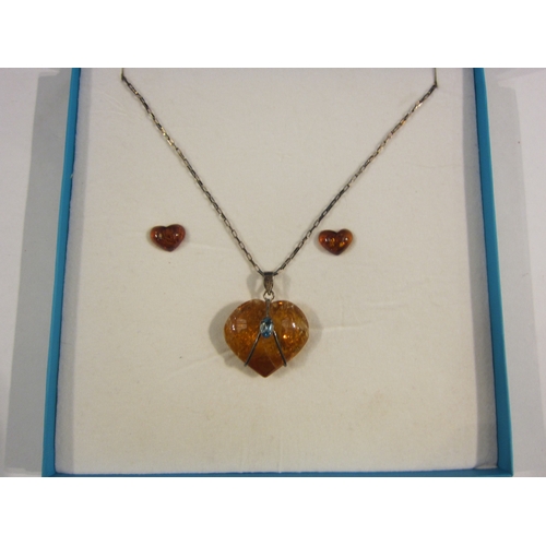 4319 - A pair of amber heart shaped earrings and a quartz and topaz pendant on chain