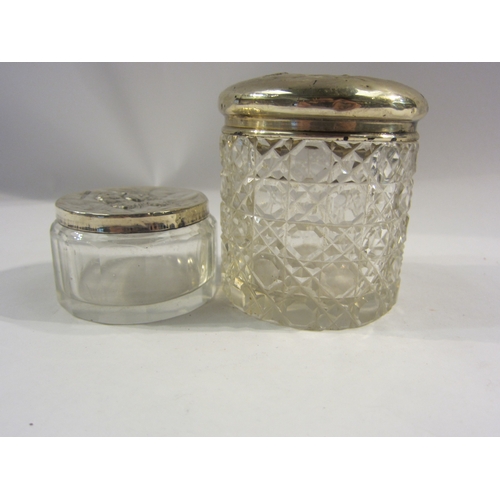 4335 - Two silver lidded cut glass jars both with cherub decoration