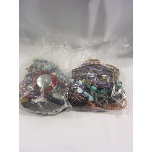 4339 - Two bags containing a large quantity of costume jewellery including amethyst, malachite, tiger's eye... 