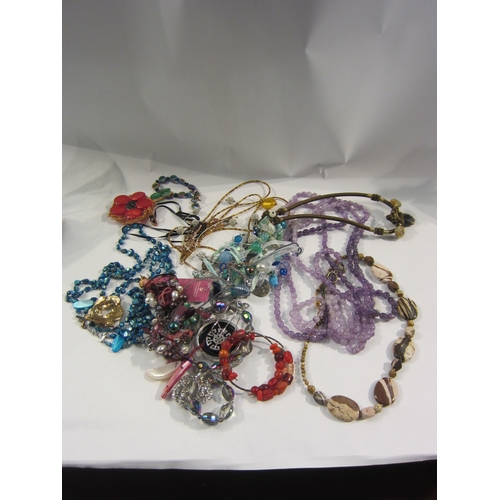 4339 - Two bags containing a large quantity of costume jewellery including amethyst, malachite, tiger's eye... 