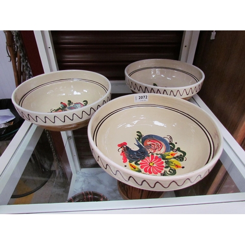 2438 - Three glazed pottery bowls with chicken design    (C)