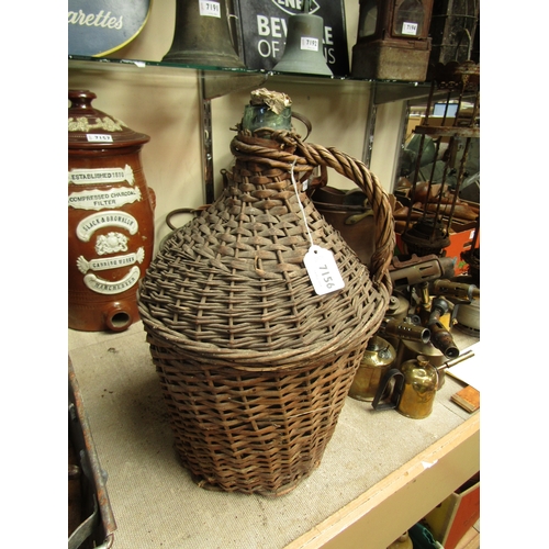 2367 - A wicker and glass flagon