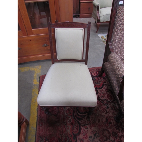 2426 - An Edwardian walnut nursing chair on ceramic castors    (D)