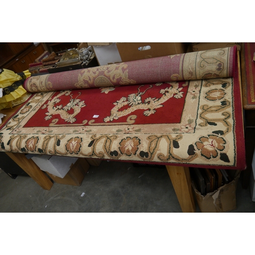 2434 - A red and cream rug