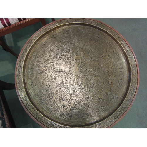 4074 - A French fruitwood circular top occasional table, the ornate brass recessed top over a turned column... 