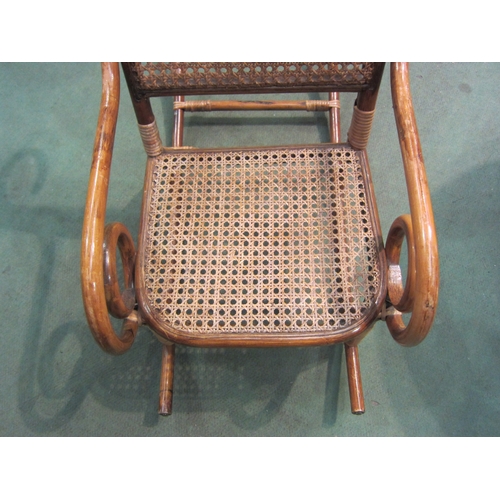 4090 - A child's bamboo rocking chair with cane seat and back rest   (R) £55