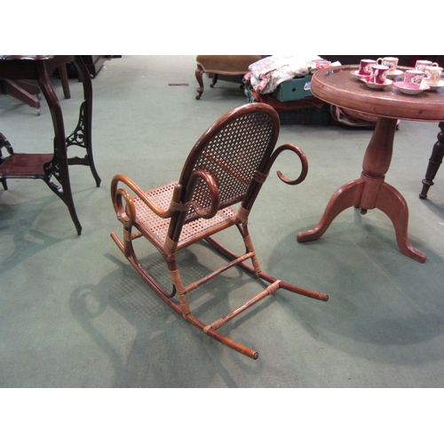 4090 - A child's bamboo rocking chair with cane seat and back rest   (R) £55