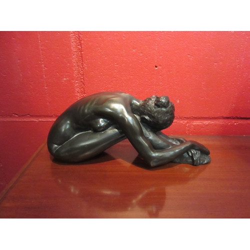 4125 - A resin bronze sculpture after Tom Greenshields, 'Chrissie Resting', 27cm long