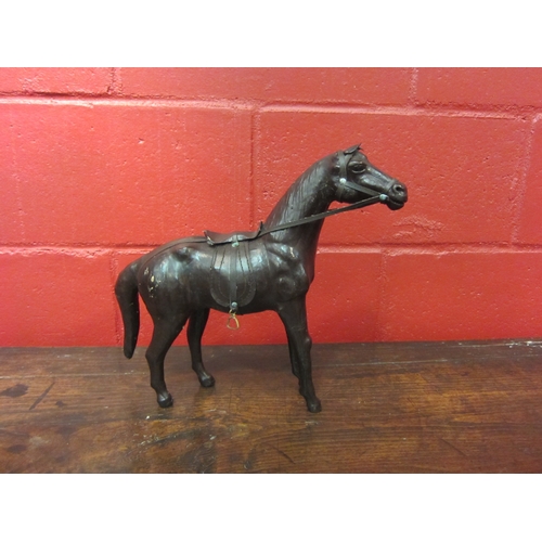 4132 - A leather horse, 32cm tall