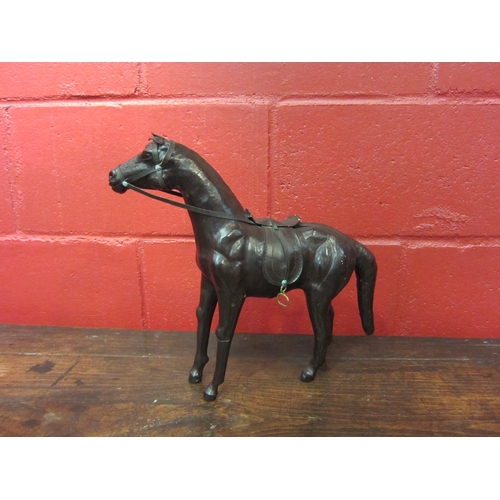 4132 - A leather horse, 32cm tall