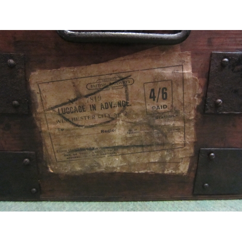 4152 - A late 19th Century metal banded trunk of small proportions with iron lifting handles, exterior labe... 