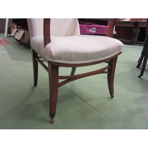 4160 - An Edwardian armchair, cream foliate design upholstery, on tapering legs to castors   (E) £20-30