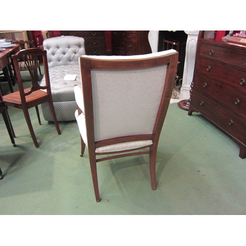 4160 - An Edwardian armchair, cream foliate design upholstery, on tapering legs to castors   (E) £20-30