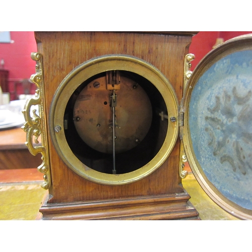 4177 - A mantel timepiece, mahogany case with brass ornamentation.  Enamel 3.5