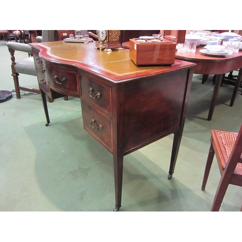 4179 - An Edwardian crossbanded mahogany breakfront desk the gilt tooled leather writing surface over a cen... 