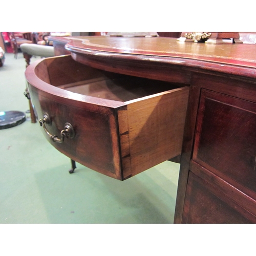 4179 - An Edwardian crossbanded mahogany breakfront desk the gilt tooled leather writing surface over a cen... 