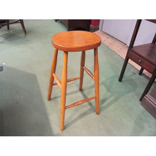 4190 - An elm and beech stool with oval seat on tapering legs united by stretchers, 65cm tall   (R) £20