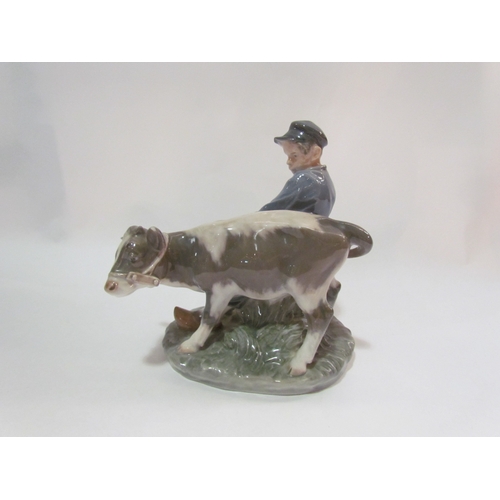 4254 - A Royal Copenhagen figure of a boy with cow (chip to ear), 17cm tall   (E) £15-25