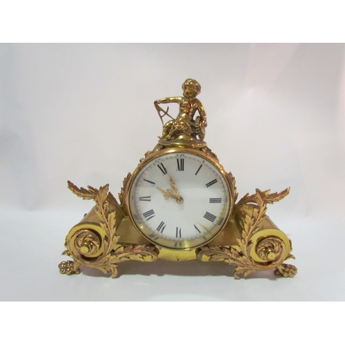 4278 - A brass drum clock, surmounted by a putti, cylindrical supports with acanthus leaves to claw feet, e... 