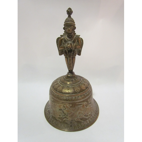 4279 - An Eastern brass bell with figural finial, animals and figural design, 21cm tall