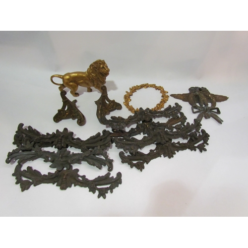 4285 - A box of brass clock and furniture ornaments, including brass lion clock top, bracket feet, etc.