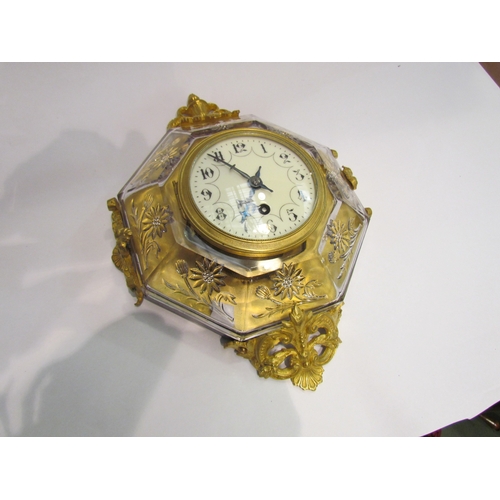 4365 - An early 20th Century French wall clock, octagonal clear glass with floral mouldings, brass case orn... 