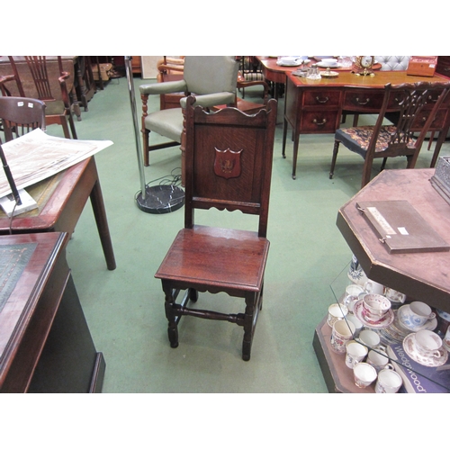 4110 - An early 18th Century oak chair with later armorial plaque, the flat seat over turned fore legs unit... 