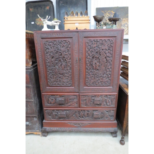 2125 - An early 20th Century Chinese carved camphor wood cupboard on chest