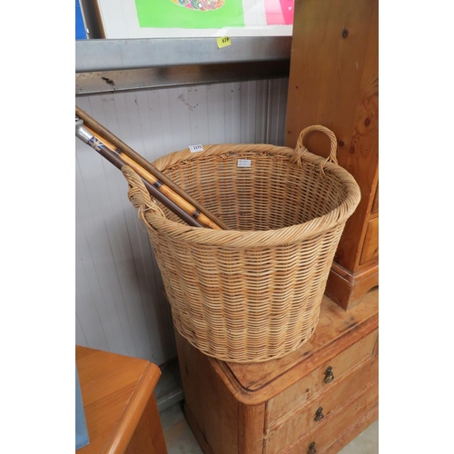 2375 - A wicker basket containg sticks