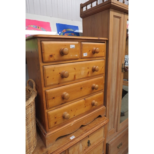 2376 - A country pine chest of two short over three long drawers, turned handles, shaped plinth base