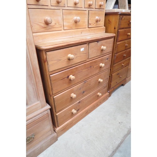 2380 - A country pine chest of two short over three long drawers, turned handles, plinth base