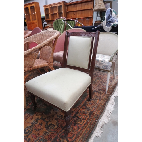 2426 - An Edwardian walnut nursing chair on ceramic castors    (D)