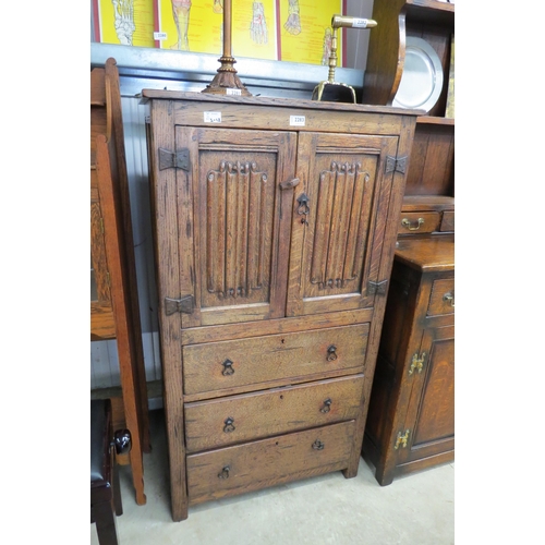 2283 - An oak linenfold cupboard, two doors over three drawers