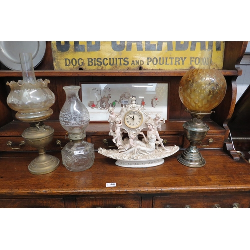 2285 - Three oil lamps and a decorative clock