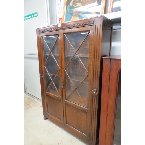 2459 - An oak + glazed 2 door bookcase