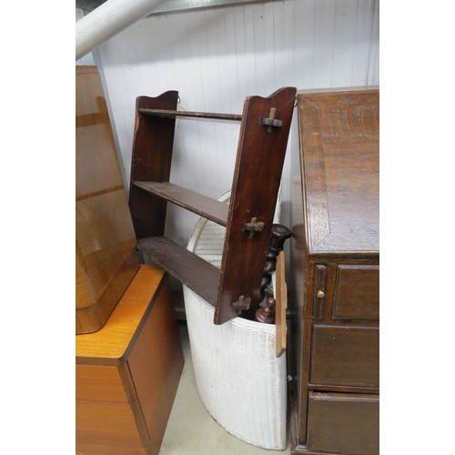 2500 - A mahogany wall shelf and Lloyd Loom filled with a selection of wooden table legs, etc