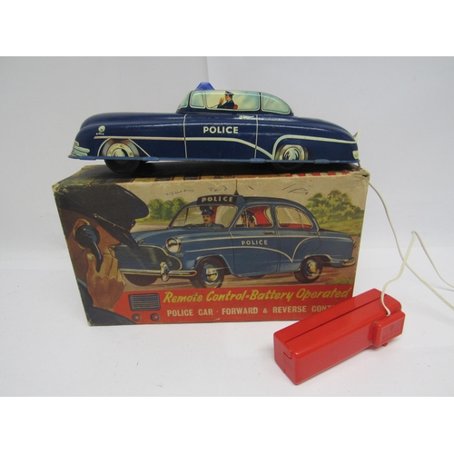 7076 - A boxed Welsotoys no.141 battery operated remote control tinplate police car with forward and revers... 