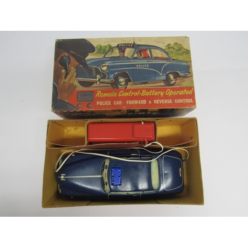 7076 - A boxed Welsotoys no.141 battery operated remote control tinplate police car with forward and revers... 