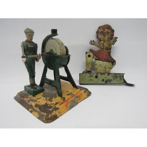 7192 - A 1920s German litho-printed clicker toy as a girl on potty, the girl raising up from the bed pan fo... 