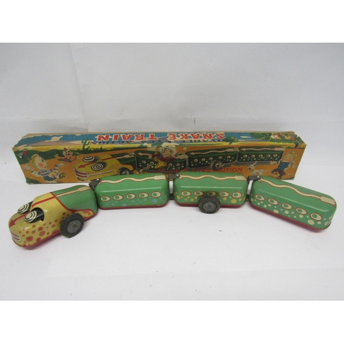 7074 - A TN Nomura (Japan) friction drive tinplate Snake Train, formed of four articulated sections with mo... 