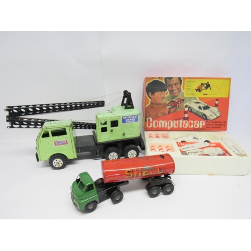 7058 - A playworn Marx Powerhouse pressed steel crane in pale green colourway, a boxed Mettoy Computacar an... 