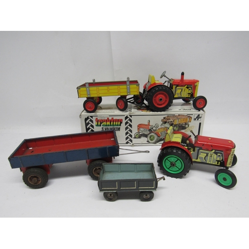 7173 - A boxed Kovap (Czech Republic) clockwork tinplate Zetor tractor and trailer, together with an unboxe... 