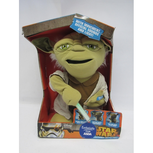 7030 - A boxed Disney Star Wars Lightsaber Battle Yoda soft toy (box crumpled)