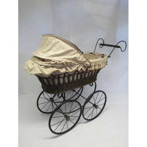 7093 - A 20th Century wicker and wrought iron dolls pram in the Victorian style       (E) £15-20