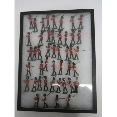 7196 - A collection of Britains military guardsmen hand painted lead figures with single articulated arms b... 