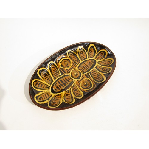 7096 - GLENYS BARTON (b.1944) A very early slipware oval dish with floral design. Signed underneath and dat... 